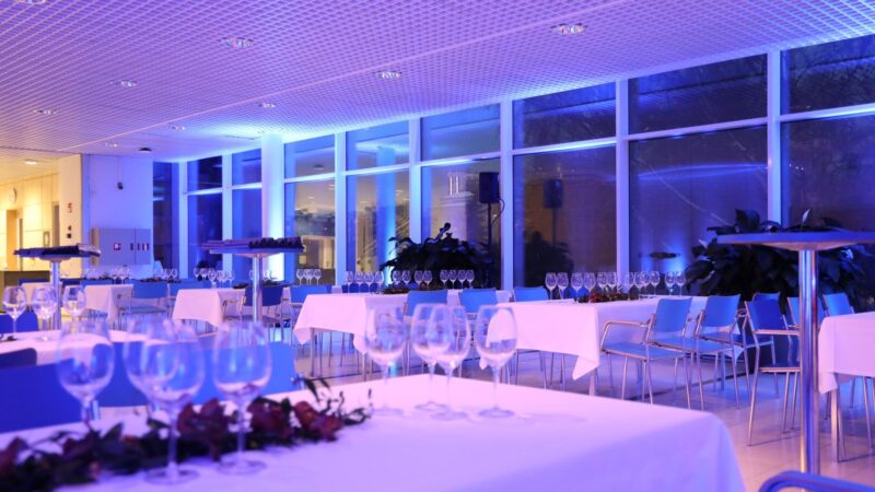 The second-floor Puistolämpiö is bathed in purple light as the space is set up for a gala dinner